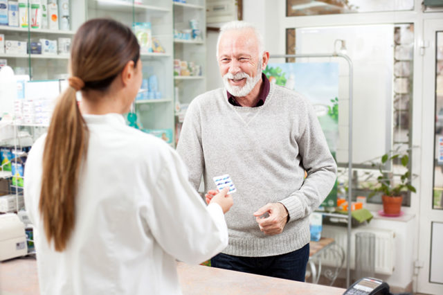 man buying medications at a drugstore Man buying medicine